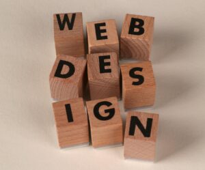 Holzklötze, die so angeordnet sind, dass sie „Webdesign“ bilden. Stellvertretend für eine kohärente Unternehmenswebsite
